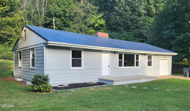 ranch-style house with a garage and a front lawn