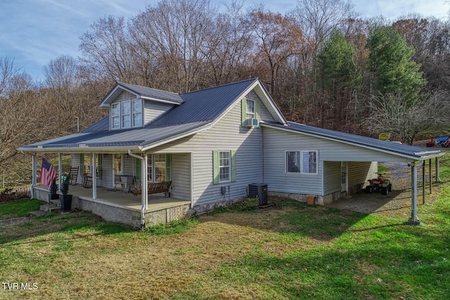 view of side of home featuring central air condition unit, a yard, and covered porch