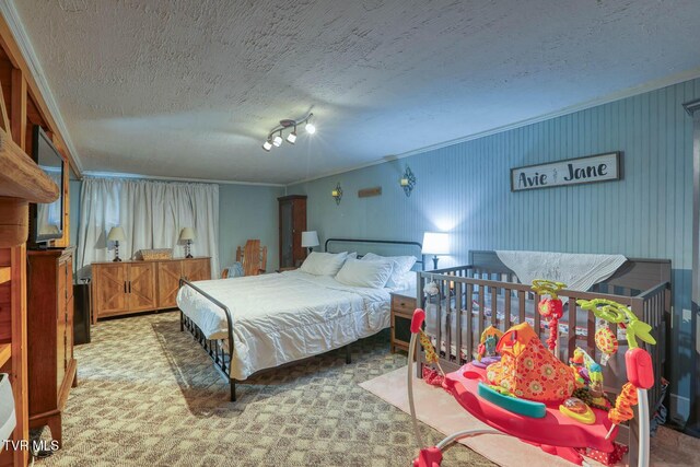 carpeted bedroom featuring a textured ceiling