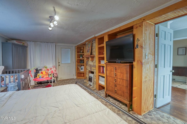 bedroom featuring wood walls, a textured ceiling, and hardwood / wood-style flooring