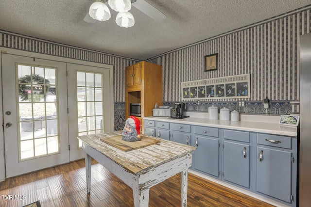 kitchen featuring french doors, a textured ceiling, dark hardwood / wood-style floors, and ceiling fan