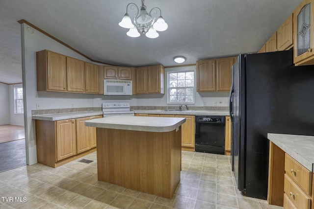 kitchen featuring a center island, black appliances, sink, decorative light fixtures, and a chandelier