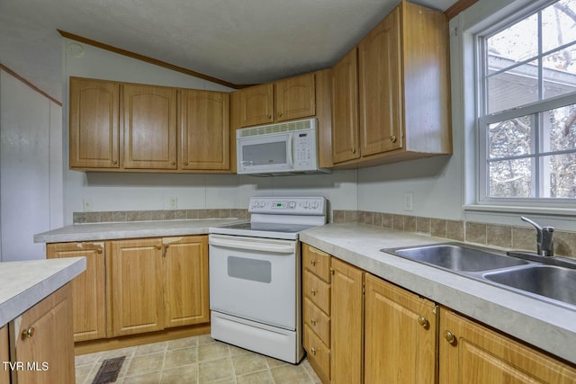 kitchen featuring sink, crown molding, vaulted ceiling, a textured ceiling, and white appliances