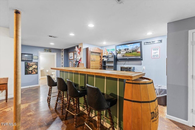 bar featuring concrete flooring