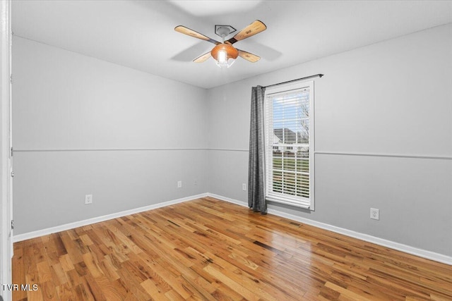 empty room with ceiling fan and hardwood / wood-style floors