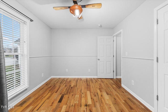 spare room featuring light hardwood / wood-style flooring and ceiling fan