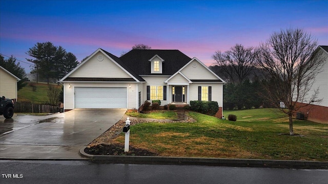 view of front of property with a lawn and a garage