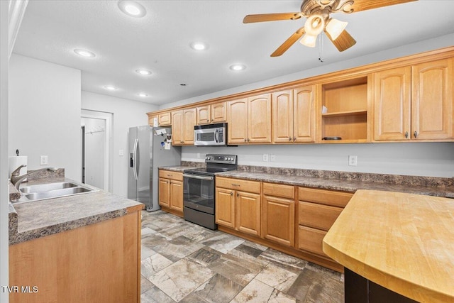 kitchen featuring appliances with stainless steel finishes, ceiling fan, and sink