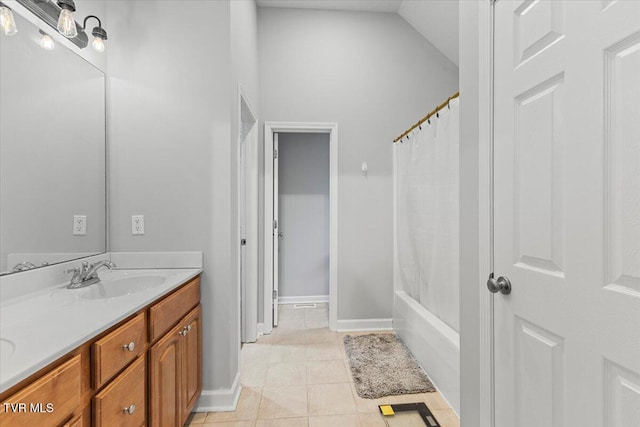 bathroom with tile patterned floors, vanity, shower / bath combo with shower curtain, and vaulted ceiling