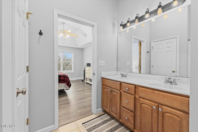 bathroom featuring vanity, hardwood / wood-style flooring, ceiling fan, and lofted ceiling