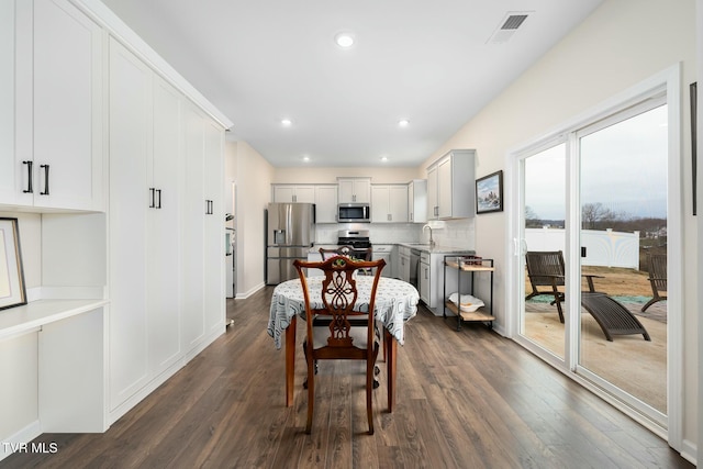 dining room with dark wood-type flooring and sink