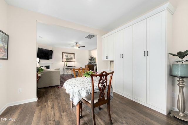 dining area with ceiling fan and dark hardwood / wood-style floors