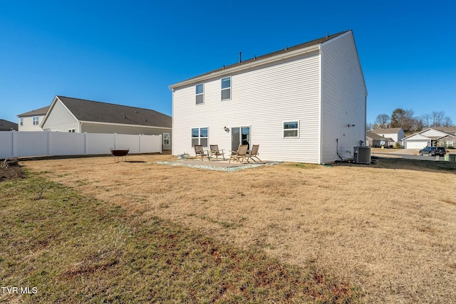 rear view of property with a patio, a lawn, and central air condition unit