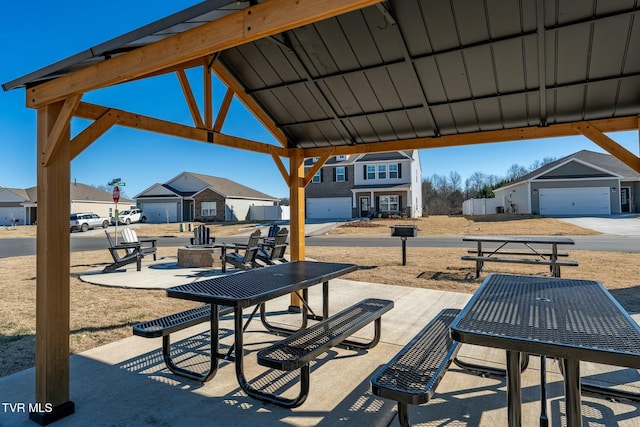 view of patio / terrace with a garage and a gazebo