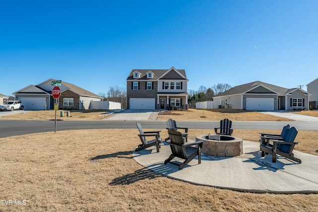 view of yard featuring a garage and an outdoor fire pit