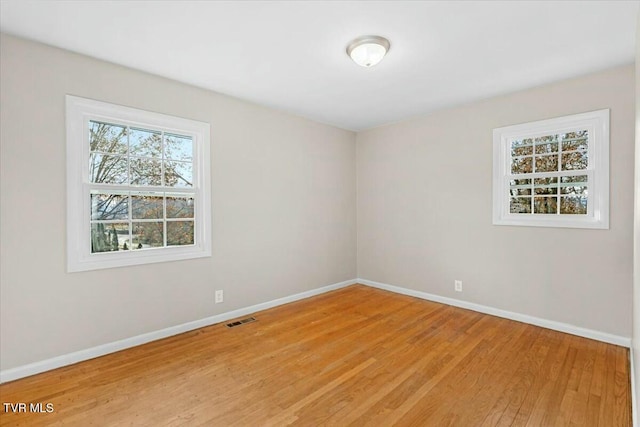 empty room with light hardwood / wood-style floors