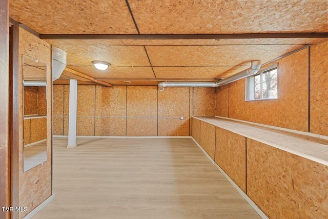 basement with light hardwood / wood-style floors