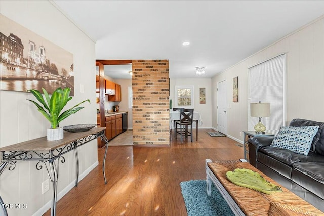 living room featuring wood-type flooring and ornamental molding