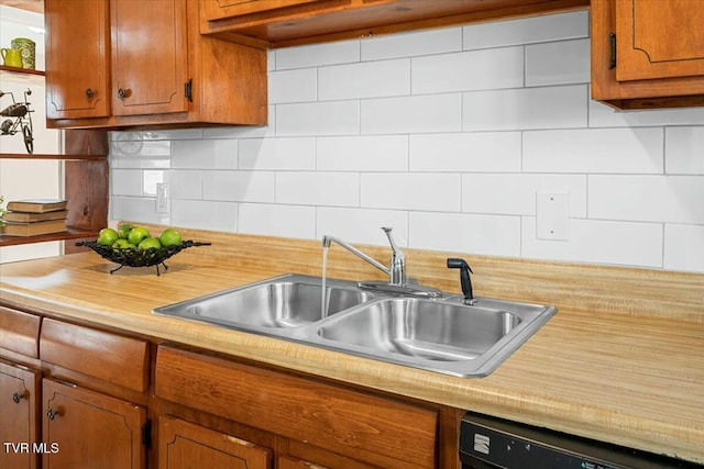 kitchen featuring tasteful backsplash, sink, and black dishwasher