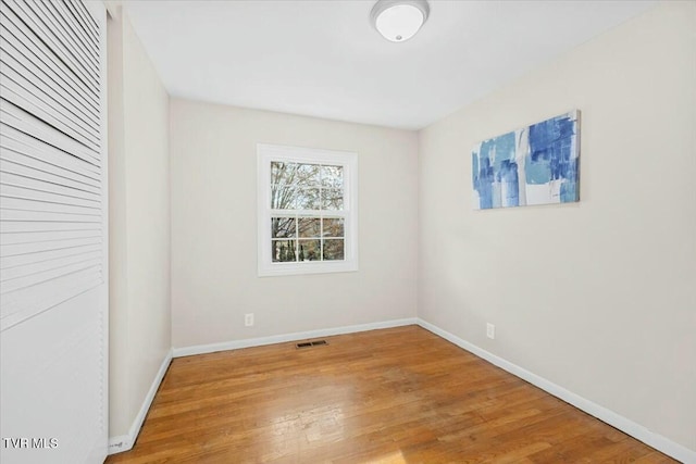 unfurnished room with hardwood / wood-style flooring