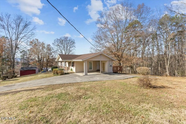 view of front of house with a carport, a porch, and a front lawn