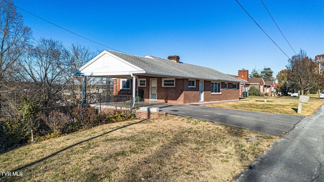 ranch-style house with a front lawn and covered porch