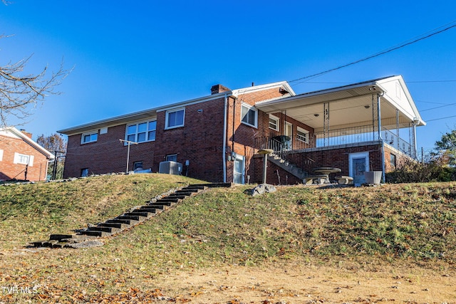 rear view of house with central AC