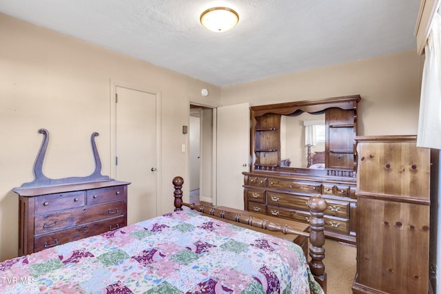 bedroom featuring carpet flooring and a textured ceiling