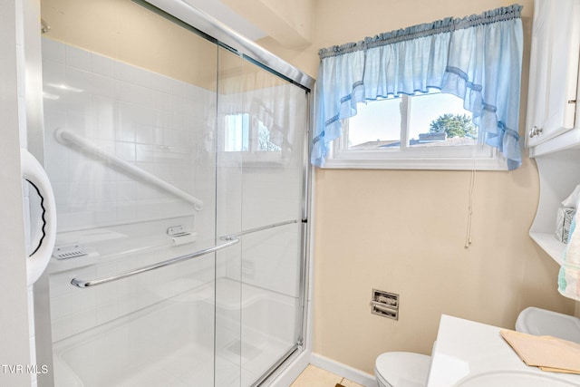 bathroom featuring vanity, toilet, and an enclosed shower