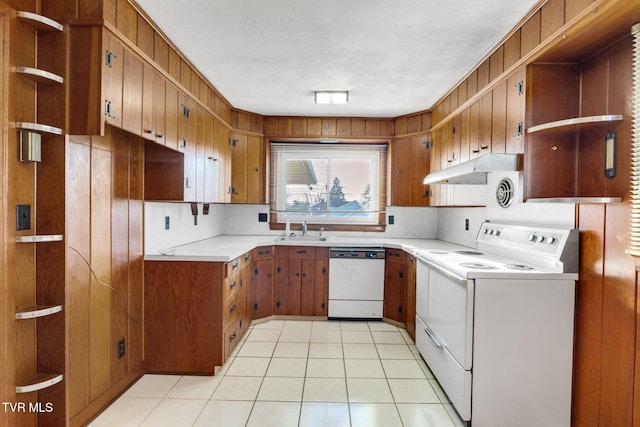 kitchen with sink, white dishwasher, decorative backsplash, light tile patterned flooring, and range