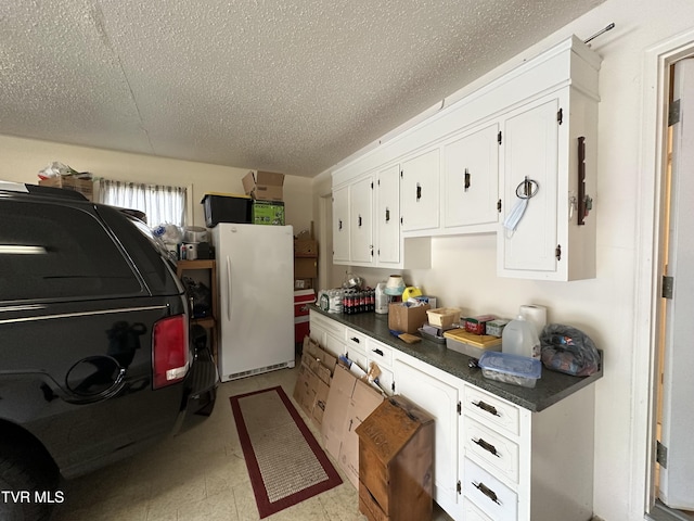 kitchen with white cabinets and white fridge