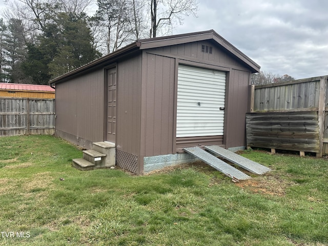 view of outdoor structure featuring a lawn