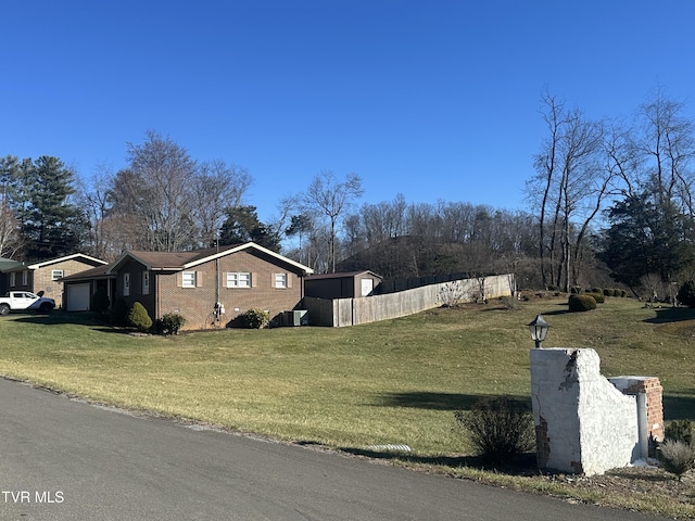 view of side of property featuring a lawn and a garage