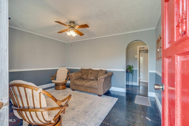 interior space with ceiling fan and ornamental molding