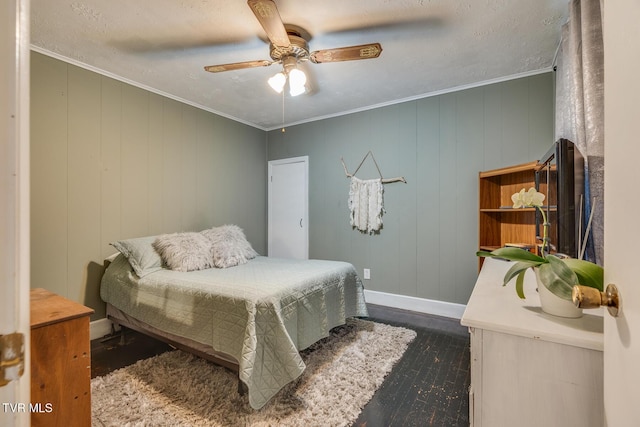 bedroom featuring ceiling fan, wood walls, dark hardwood / wood-style floors, and ornamental molding