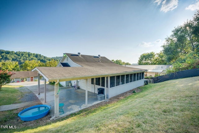 back of property featuring a patio and a lawn