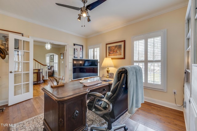 office area with a wealth of natural light, french doors, and light hardwood / wood-style floors