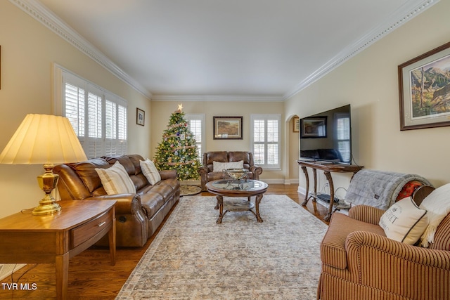 living room with hardwood / wood-style floors, ornamental molding, and a wealth of natural light