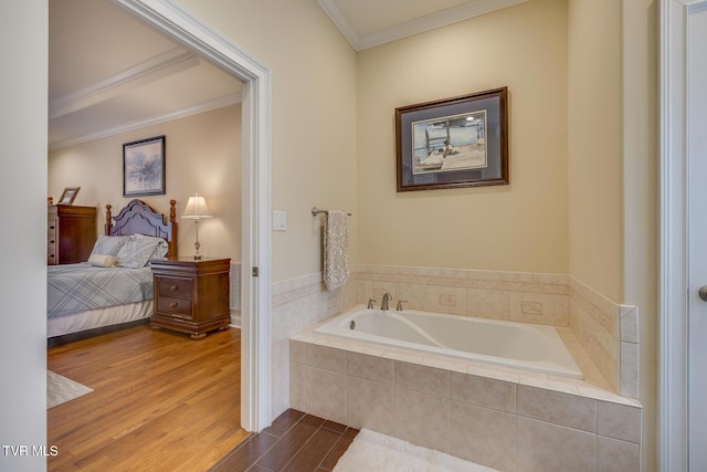 bathroom with hardwood / wood-style flooring, a relaxing tiled tub, and crown molding