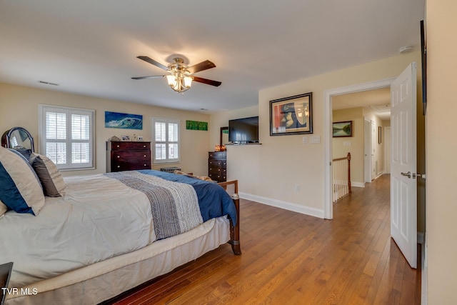 bedroom with ceiling fan and hardwood / wood-style flooring