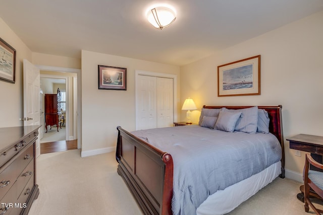 bedroom featuring light carpet and a closet