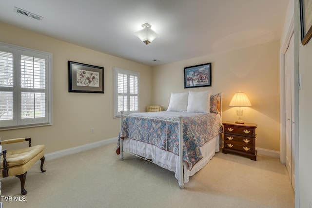 carpeted bedroom with multiple windows