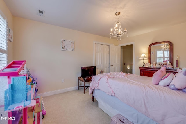 carpeted bedroom with a chandelier, a closet, and multiple windows