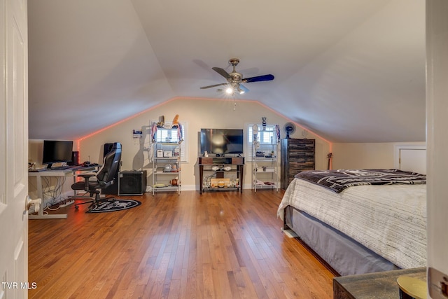 bedroom with wood-type flooring, ceiling fan, and lofted ceiling