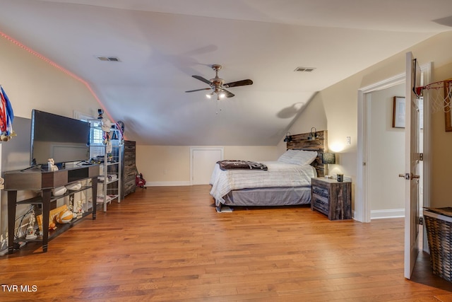 bedroom with ceiling fan, light wood-type flooring, and vaulted ceiling