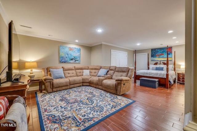 living room with hardwood / wood-style flooring and crown molding