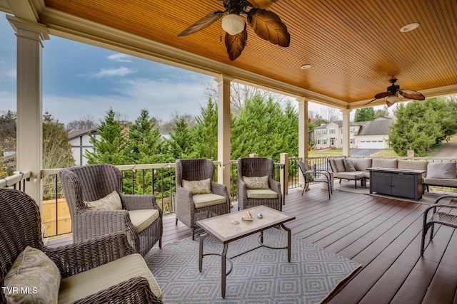 deck with an outdoor living space and ceiling fan