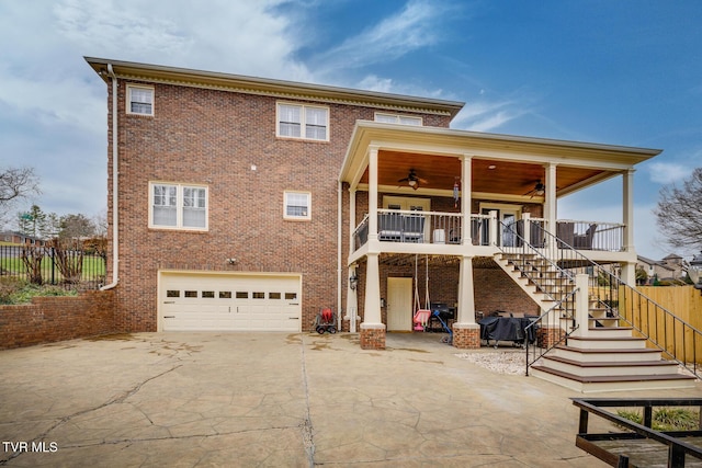 back of house with a garage and ceiling fan