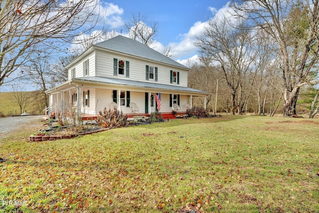 farmhouse with a porch and a front lawn