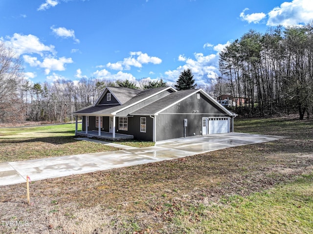 view of front of home with a porch, a garage, and a front yard